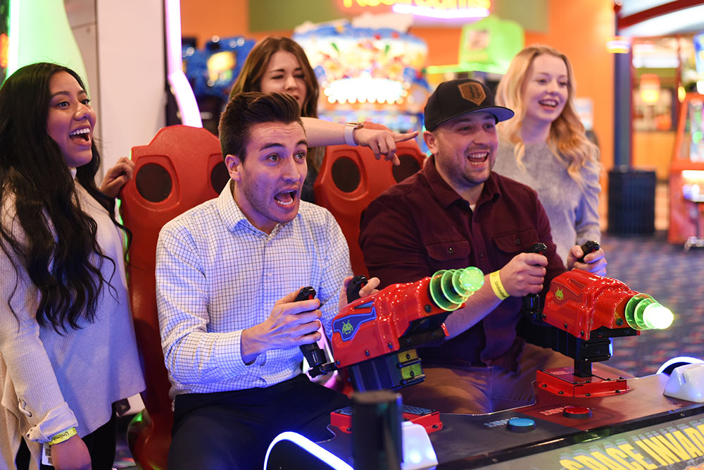Company-Picnic-Indoor-Unlimited Group Playing Spaced Invaders Arcade Game