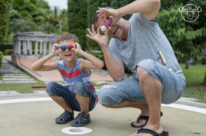 GOLF3 Dad and son acting silly with golf balls
