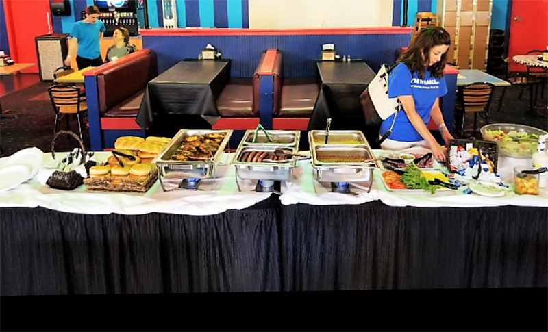 company-picnic-setup buffet setup with burgers, hot dogs, condiments